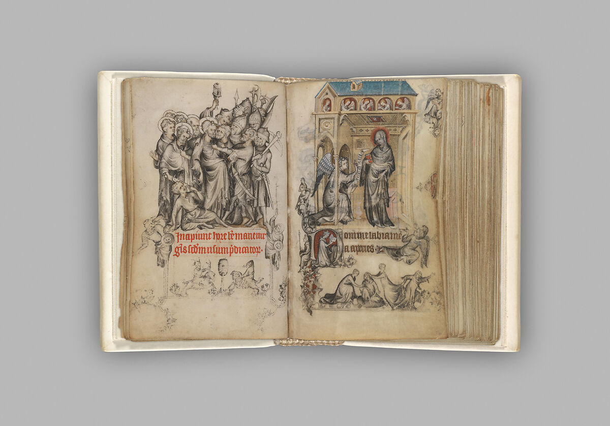 A photograph of a Medieval book of hours prayer book, written in Latin and illuminated with drawings of Mary and angels.
